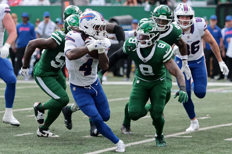 Sep 14, 2025; East Rutherford, New Jersey, USA; Buffalo Bills running back James Cook (4) rushes the ball past New York Jets safety Andre Cisco (8) during the second half at MetLife Stadium. Mandatory Credit: Vincent Carchietta-Imagn Images
