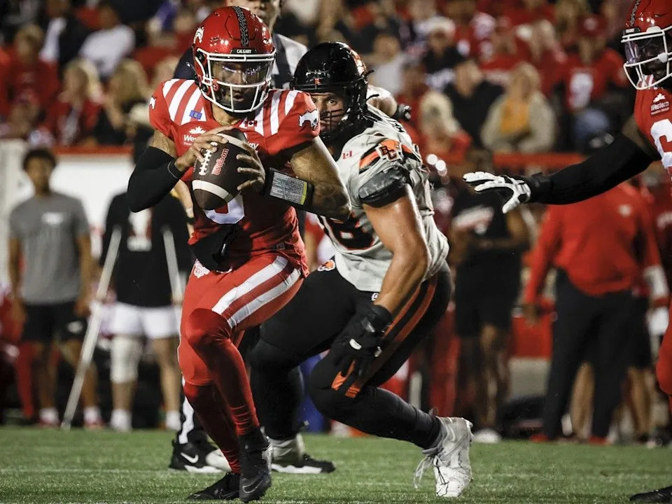 BC Lions’ Levi Bell, right, chases Calgary Stampeders quarterback Vernon Adams Jr. during first half CFL football action in Calgary, Friday, Sept. 19, 2025.THE CANADIAN PRESS/Jeff McIntosh