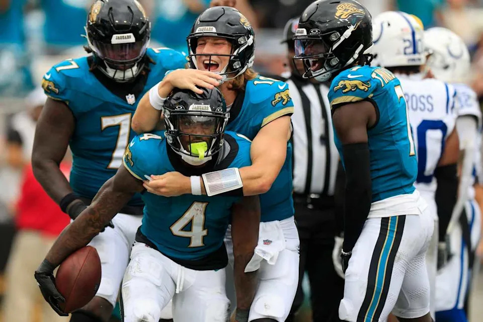 Jacksonville Jaguars quarterback Trevor Lawrence (16) celebrates a touchdown scored by running back Tank Bigsby (4) during the third quarter of NFL football matchup Sunday, Oct. 6, 2024 at EverBank Stadium in Jacksonville, Fla. The Jaguars edged the Colts on a field goal 37-34.© Corey Perrine/Florida Times-Union / USA TODAY NETWORK via Imagn Images