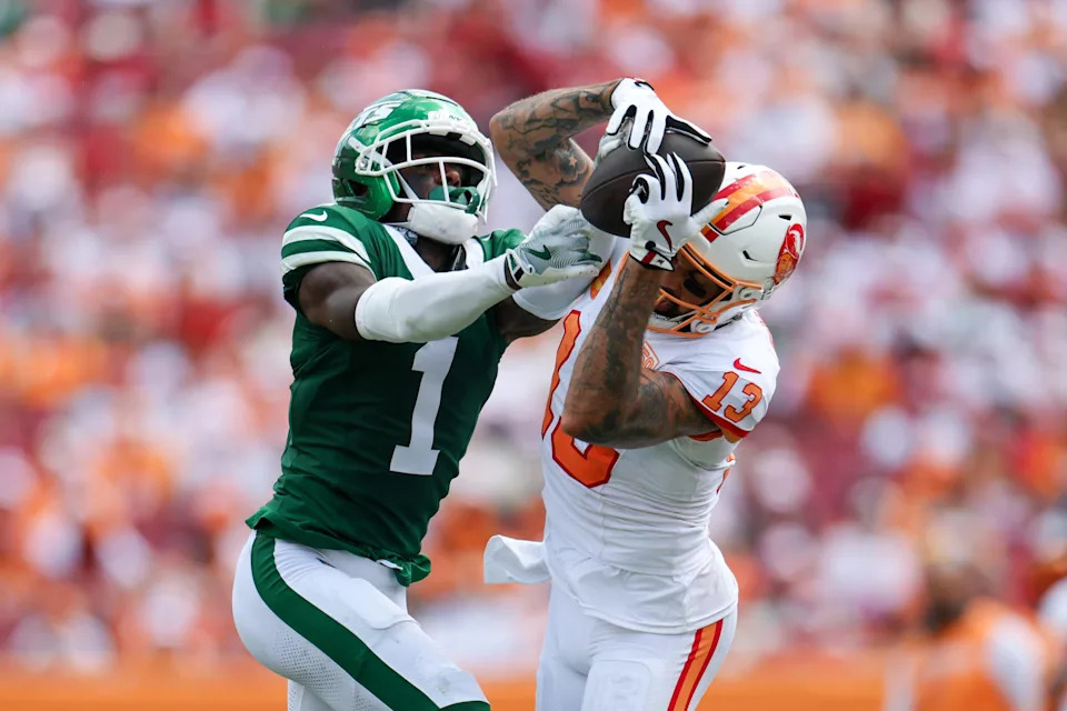 Sep 21, 2025; Tampa, Florida, USA; Tampa Bay Buccaneers wide receiver Mike Evans (13) catches pass defended boy New York Jets cornerback Sauce Gardner (1) in the third quarter at Raymond James Stadium. Mandatory Credit: Nathan Ray Seebeck-Imagn Images