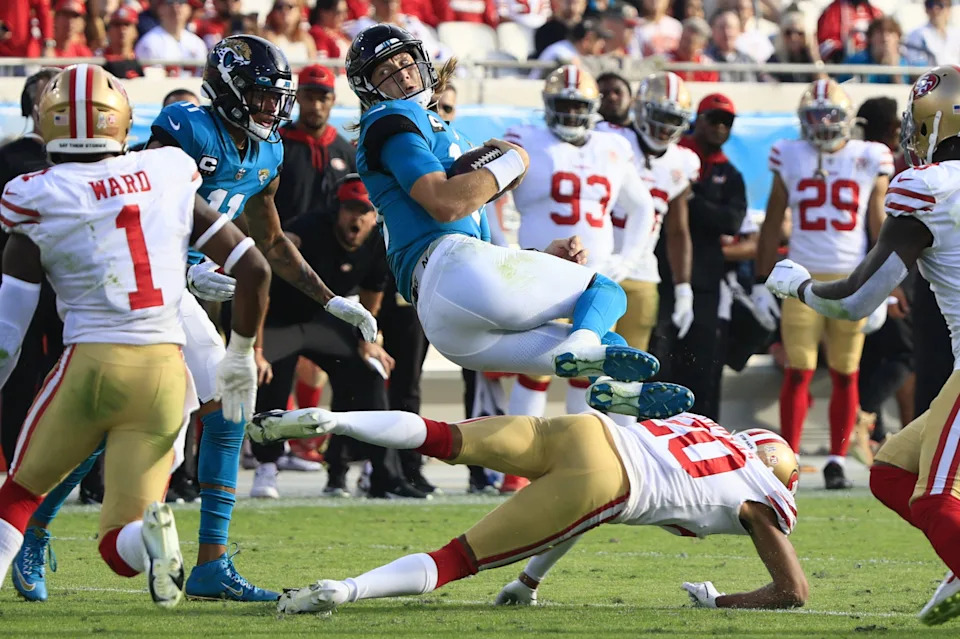Jacksonville Jaguars quarterback Trevor Lawrence (16) twists and leaps over San Francisco 49ers cornerback Ambry Thomas (20) during the fourth quarter at TIAA Bank Field Sunday, Nov. 21, 2021 in Jacksonville. The Jacksonville Jaguars hosted the San Francisco 49ers during a regular season NFL game. The 49ers defeated the Jaguars 30-10. [Corey Perrine/Florida Times-Union]