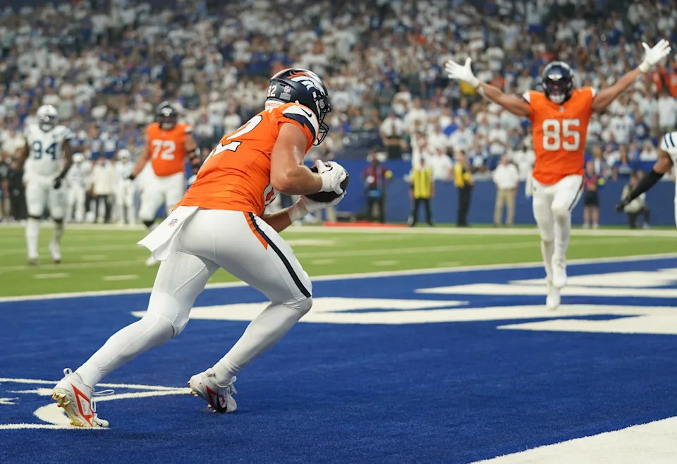 Sep 14, 2025; Indianapolis, Indiana, USA; Denver Broncos tight end Adam Trautman (82) receives a pass from quarterback Bo Nix (10) (not pictured) to score a touchdown during the second quarter against the Indianapolis Colts at Lucas Oil Stadium. Mandatory Credit: Robert Goddin-Imagn Images