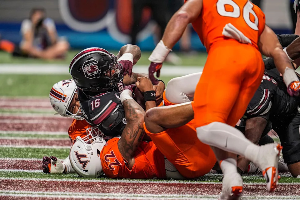 Aug 31, 2025; Atlanta, Georgia, USA; South Carolina Gamecocks quarterback LaNorris Sellers (16) is tackled for a safety by Virginia Tech Hokies defensive lineman Kelvin Gilliam Jr. (22) during the first quarter at Mercedes-Benz Stadium. Mandatory Credit: Dale Zanine-Imagn Images