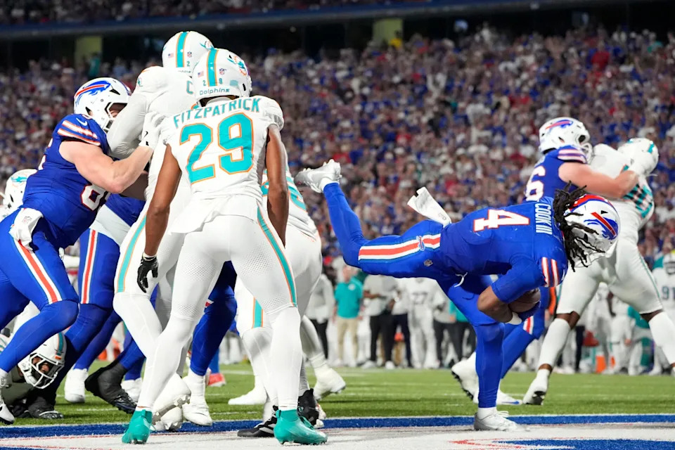 Sep 18, 2025; Orchard Park, New York, USA; Buffalo Bills running back James Cook (4) scores a touchdown against the Miami Dolphins in the third quarter at Highmark Stadium. Mandatory Credit: Gregory Fisher-Imagn Images