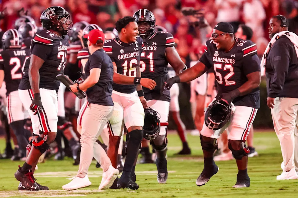 Sep 27, 2025; Columbia, South Carolina, USA; South Carolina Gamecocks quarterback LaNorris Sellers (16) and offensive lineman Nick Sharpe (52) celebrate a defensive touchdown against the Kentucky Wildcats in the second quarter at Williams-Brice Stadium. Mandatory Credit: Jeff Blake-Imagn Images