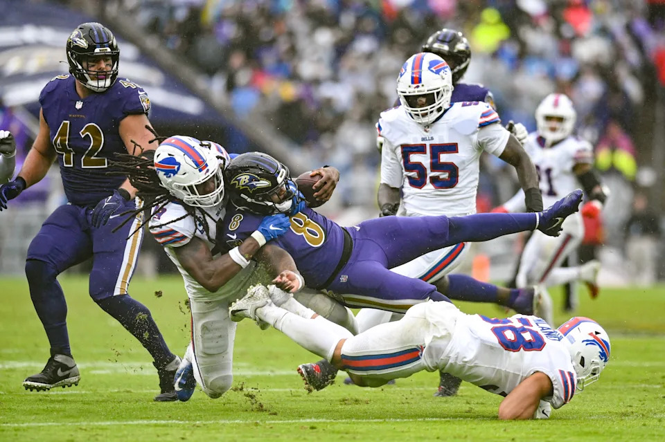 Oct 2, 2022; Baltimore, Maryland, USA; Buffalo Bills linebacker Tremaine Edmunds (49 and linebacker Matt Milano (58) tackle Baltimore Ravens quarterback Lamar Jackson (8) during the second half at M&T Bank Stadium. Mandatory Credit: Tommy Gilligan-USA TODAY Sports
