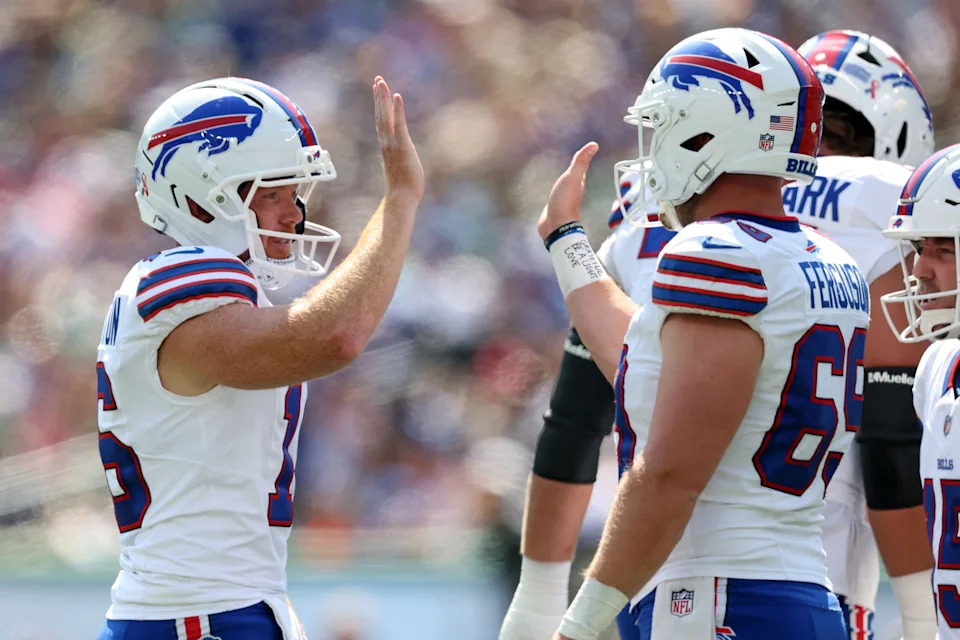Sep 14, 2025; East Rutherford, New Jersey, USA; Buffalo Bills punter Cameron Johnston (16) reacts with long snapper Reid Ferguson (69) during the first half at MetLife Stadium. Mandatory Credit: Vincent Carchietta-Imagn Images