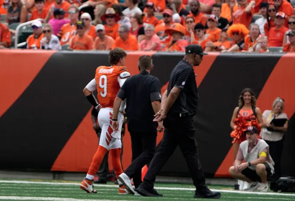 Cincinnati Bengals quarterback Joe Burrow walks off the field after a toe injury during NFL...