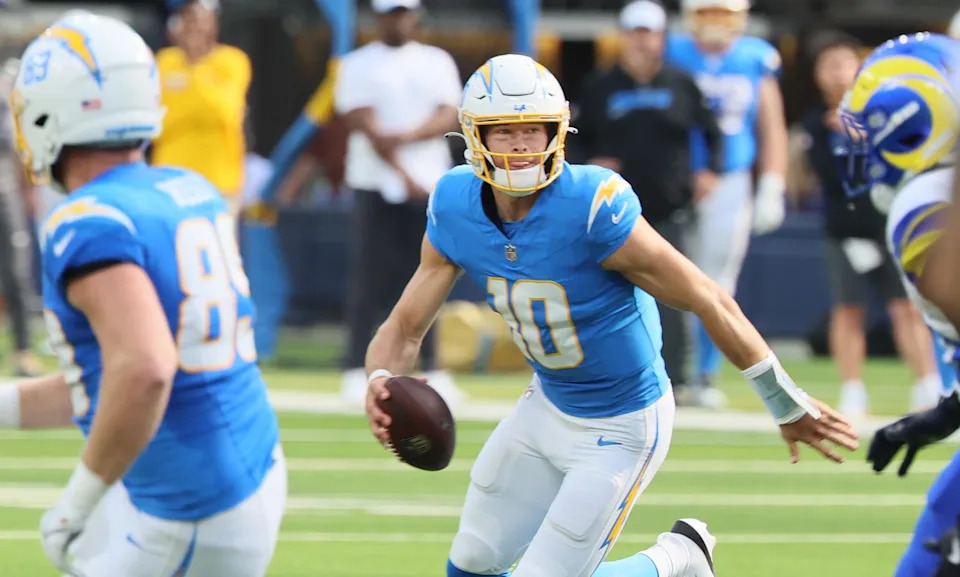 Chargers quarterback Justin Herbert scrambles against the Rams in a preseason game on Aug. 16.