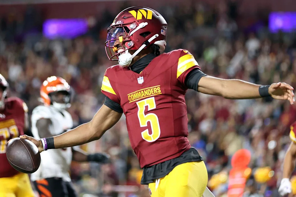 Washington Commanders quarterback Jayden Daniels celebrates after scoring in a preseason game.