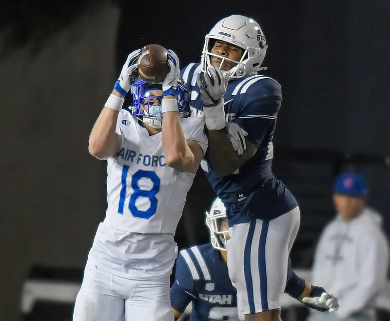 Air Force wide receiver Quin Smith (18) catches a pass as Utah State linebacker William Holmes defends during the second half Saturday Sept. 13, 2025, in Logan, Utah. | Eli Lucero/Herald Journal