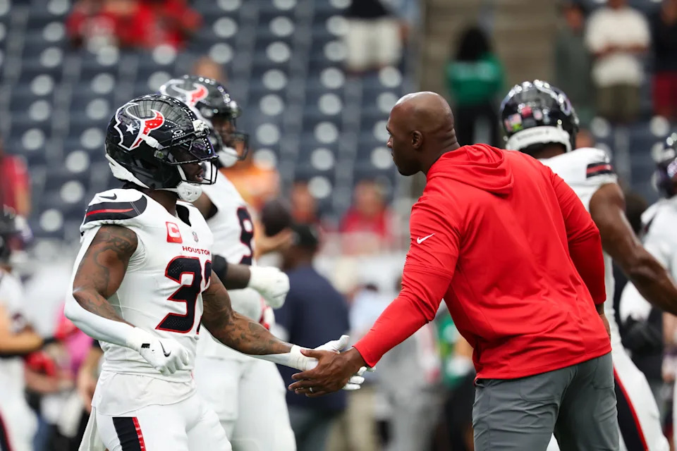 Sep 15, 2025; Houston, Texas, USA; Houston Texans head coach DeMeco Ryans high fives Houston Texans running back Dare Ogunbowale (33) before the game against the Tampa Bay Buccaneers at NRG Stadium. Mandatory Credit: Thomas Shea-Imagn Images