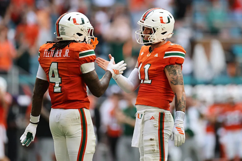 MIAMI GARDENS, FLORIDA - SEPTEMBER 13: Carson Beck #11 of the Miami Hurricanes and Mark Fletcher Jr. #4 of the Miami Hurricanes celebrate Beck's pass for a touchdown against the South Florida Bulls during the first half at Hard Rock Stadium on September 13, 2025 in Miami Gardens, Florida. (Photo by Carmen Mandato/Getty Images)