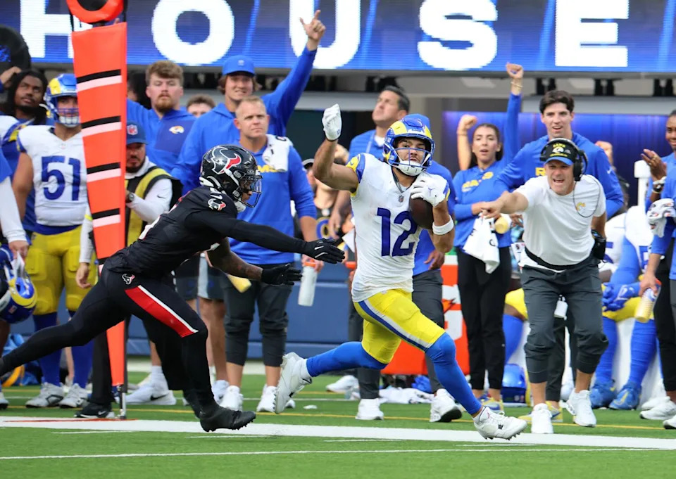 Rams wide receiver Puka Nacua evades a Houston Texans defender after making a catch during the Rams' win on Sept. 7.
