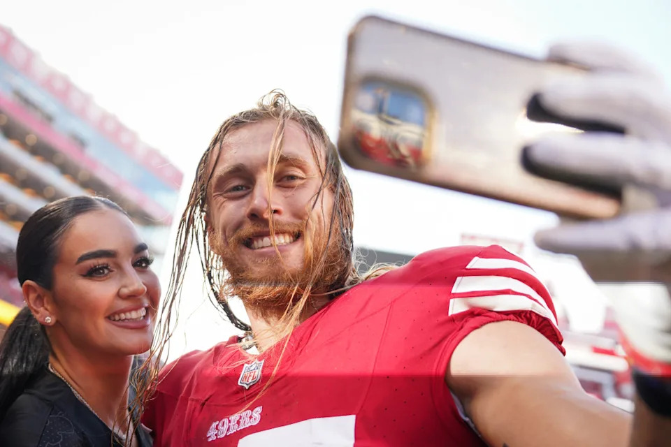 SANTA CLARA, CALIFORNIA - AUGUST 25: George Kittle #85 of the San Francisco 49ers takes a selfie with his wife, Claire, being playing the Los Angeles Chargers in a preseason game at Levi's Stadium on August 25, 2023 in Santa Clara, California. (Photo by Loren Elliott/Getty Images)Loren Elliott&sol;Getty Images