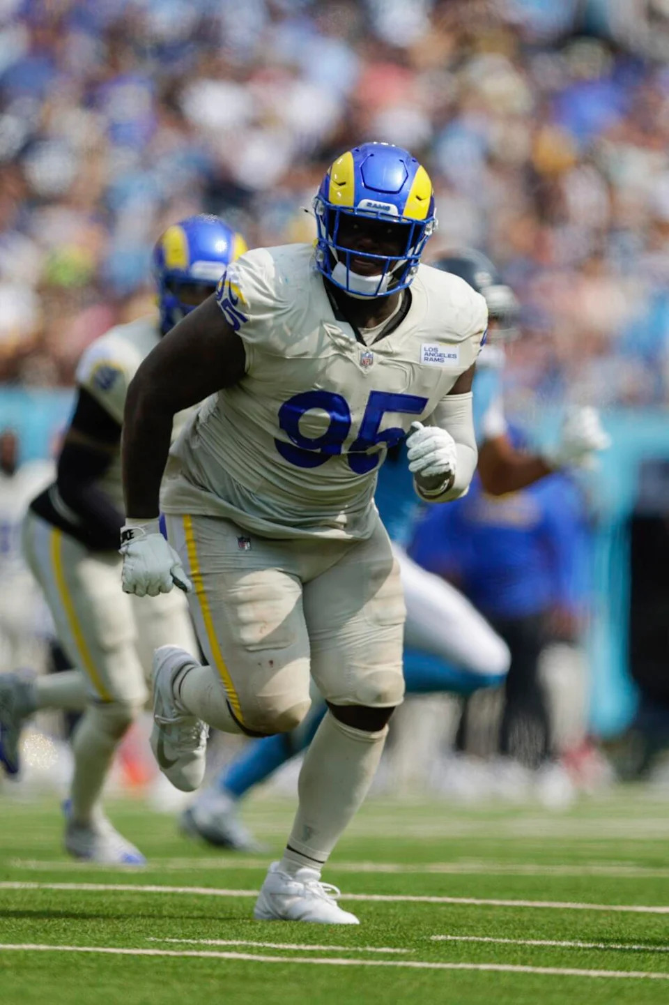 Rams defensive tackle Poona Ford runs on the field during a game against the Titans.