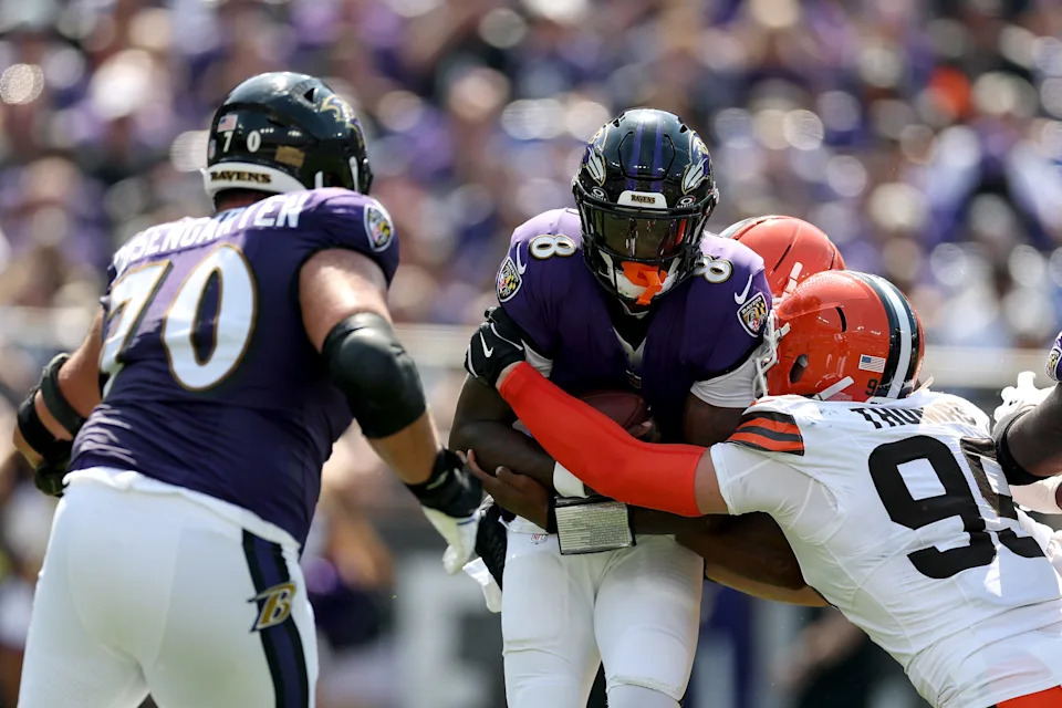 BALTIMORE, MARYLAND - SEPTEMBER 14: Quarterback Lamar Jackson #8 of the Baltimore Ravens is sacked by defensive end Cameron Thomas #99 of the Cleveland Browns at M&T Bank Stadium on September 14, 2025 in Baltimore, Maryland. (Photo by Rob Carr/Getty Images)