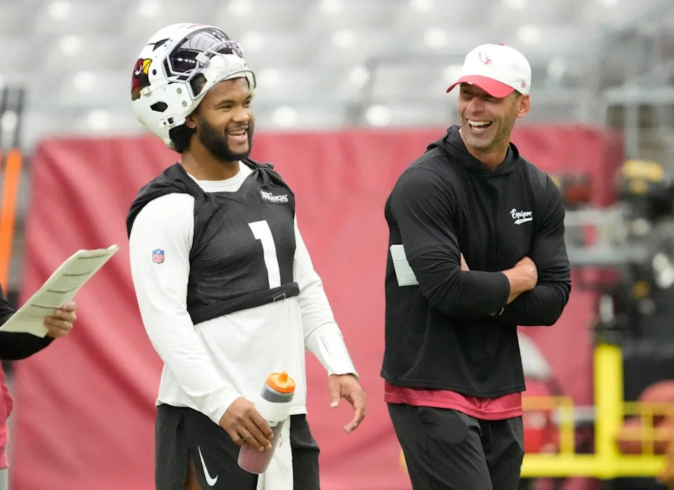 Arizona Cardinals quarterback Kyler Murray (1) and head coach Jonathan Gannon share a laugh during training camp July 27, 2025.
