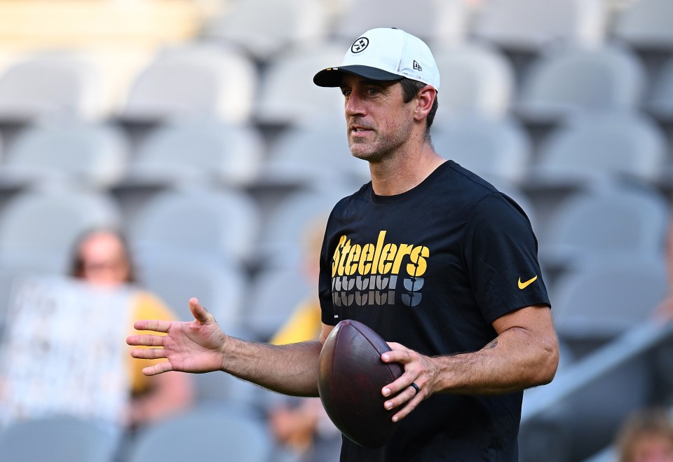 Aaron Rodgers, Pittsburgh Steelers quarterback, holding a football.