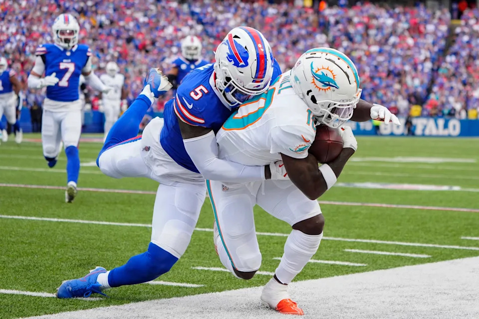 Nov 3, 2024; Orchard Park, New York, USA; Buffalo Bills cornerback Kiir Elam (5) tackles Miami Dolphins wide receiver Tyreek Hill (10) after making a catch during the second half at Highmark Stadium. Mandatory Credit: Gregory Fisher-Imagn Images
