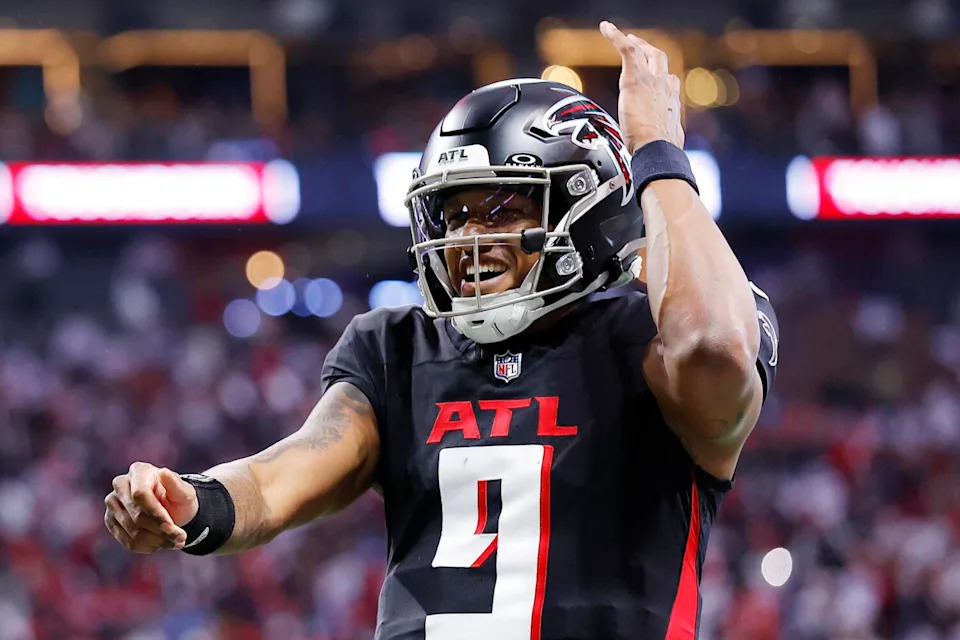 Atlanta Falcons quarterback Michael Penix celebrates after throwing a touchdown pass.