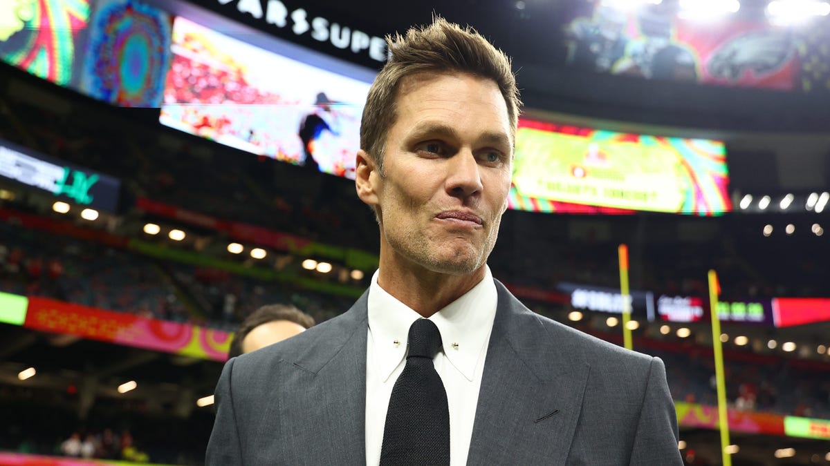 Why is Tom Brady in the Raiders' coaches box?