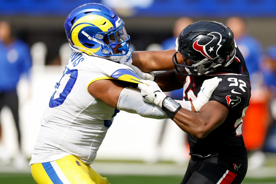 Los Angeles Rams' Tyler Davis #90 and Houston Texans' Dylan Horton #92 in a football game.