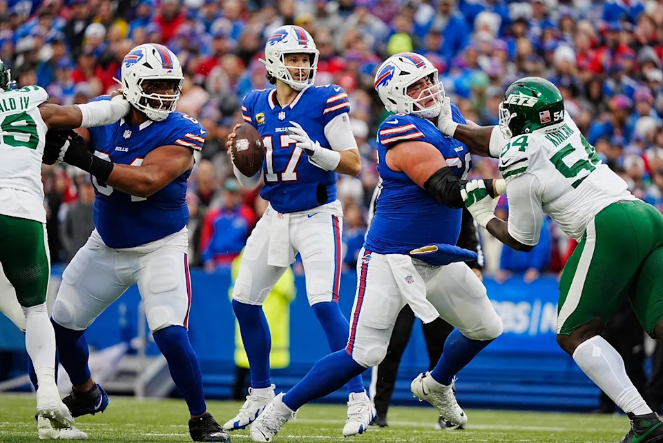 Buffalo Bills quarterback Josh Allen (17) gets pass protection from Buffalo Bills guard O'Cyrus Torrence (64) and Buffalo Bills guard Connor McGovern (66) during first half action at the Bills home game against the New York Jets at Highmark Stadium in Orchard Park on Dec. 29, 2024.