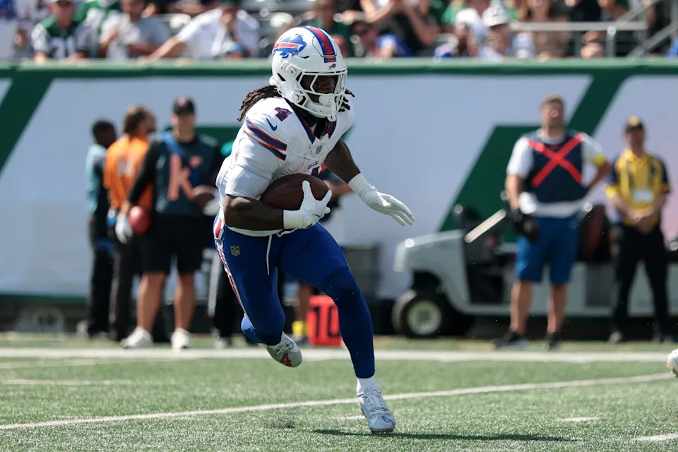 Sep 14, 2025; East Rutherford, New Jersey, USA; Buffalo Bills running back James Cook (4) rushes the ball against the New York Jets during the first half at MetLife Stadium. Mandatory Credit: Vincent Carchietta-Imagn Images