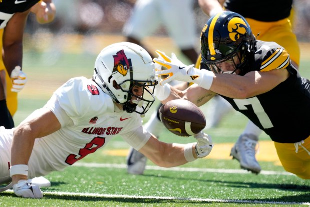 Illinois State wide receiver Braden Contreras (9) recovers a fumbled punt in front of Iowa defensive back John Nestor (7) during the first half of an NCAA college football game, Saturday, Aug. 31, 2024, in Iowa City, Iowa. (AP Photo/Charlie Neibergall)