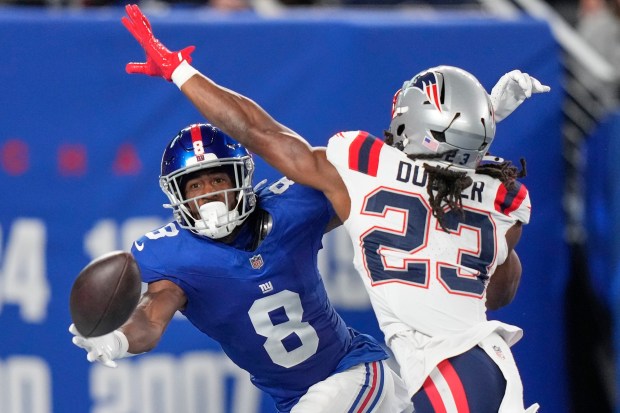 New York Giants wide receiver Beaux Collins (8) can't make the catch against New England Patriots safety Kyle Dugger during the second quarter of an NFL game Thursday in East Rutherford, N.J. (AP Photo/Frank Franklin II)