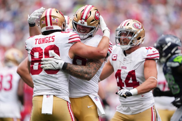 San Francisco 49ers tight end Jake Tonges (88) celebrates with tight end Luke Farrell, center, after a touchdown during the second half of an NFL football game against the Seattle Seahawks, Sunday, Sept. 7, 2025, in Seattle. (AP Photo/Lindsey Wasson)