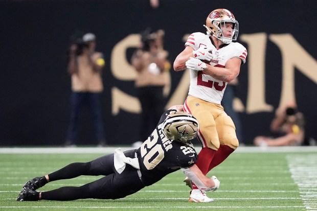 San Francisco 49ers running back Christian McCaffrey, right, catches a...