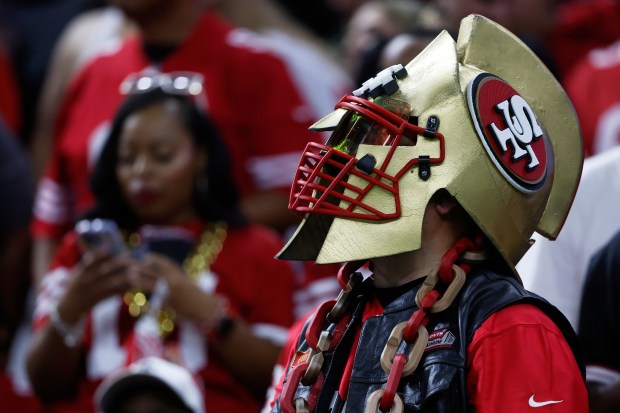 A San Francisco 49ers fan watches during the second half...