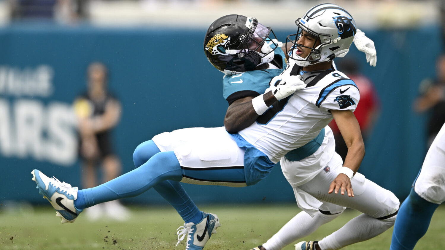 Jacksonville Jaguars cornerback Jourdan Lewis (2) tackles Carolina Panthers quarterback Bryce Young...