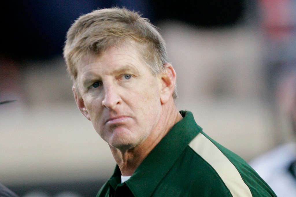 South Florida coach Jim Leavitt is escorted off the field after losing to Louisville in an NCAA college football game in Louisville, Ky., Saturday, Oct. 25, 2008.