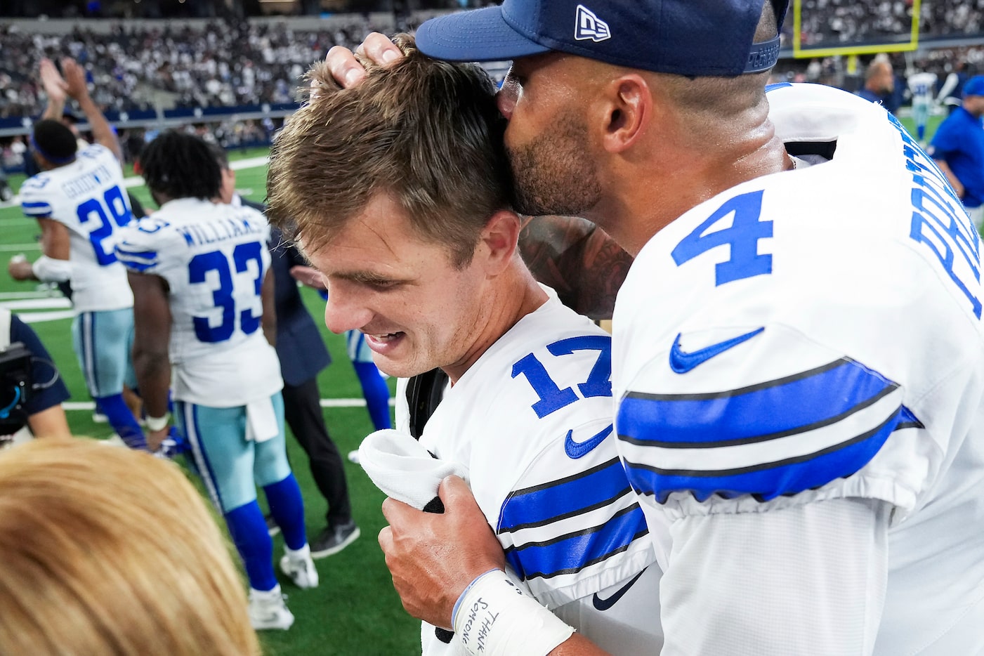 Dallas Cowboys place kicker Brandon Aubrey (17) gets a kiss from quarterback Dak Prescott...