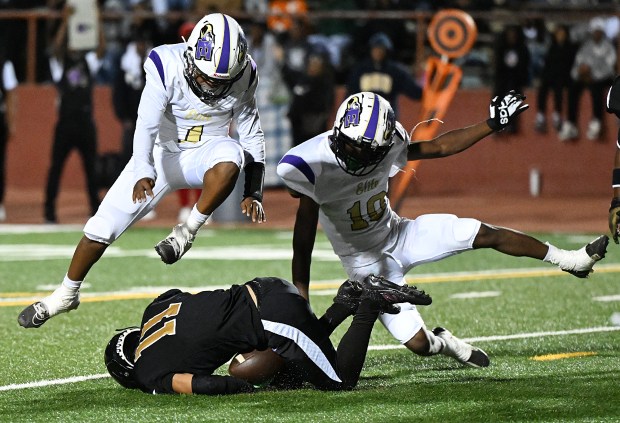 Elite quarterback, Ma'Kai Little, and D'Sir Tyler jump over Bethel's Kevin Fuentes as Fuentes recovers a fumbled snap during the Jaguars' 37-12 win on Thursday in Vallejo. (Chris Riley/Times-Herald)