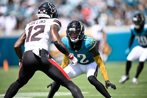 Jacksonville Jaguars defensive back Travis Hunter (12) covers Houston Texans wide receiver Nico Collins (12) during the first half of an NFL football game, Sunday, Sept. 21, 2025, in Jacksonville, Fla. (AP Photo/Phelan M. Ebenhack)