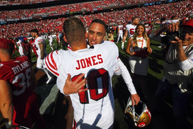 San Francisco 49ers kicker Eddy Pineiro (18) receives a hug from quarterback Mac Jones (10) after defeating the Arizona Cardinals during their NFL game at Levi's Stadium in Santa Clara, Calif., on Sunday, Sept. 21, 2025. San Francisco 49ers defeated the Arizona Cardinals 16-15. (Jose Carlos Fajardo/Bay Area News Group)