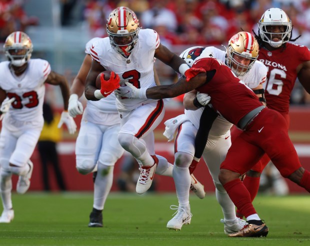 San Francisco 49ers' Brian Robinson Jr. (3) runs against Arizona Cardinals' Mack Wilson Sr. (2) in the fourth quarter at Levi's Stadium in Santa Clara, Calif., on Sunday, Sept. 21, 2025. (Nhat V. Meyer/Bay Area News Group)