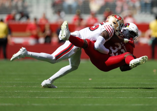 San Francisco 49ers' Jason Pinnock (25) tackles Arizona Cardinals' Trey Benson (33) after a catch in the second quarter at Levi's Stadium in Santa Clara, Calif., on Sunday, Sept. 21, 2025. (Nhat V. Meyer/Bay Area News Group)