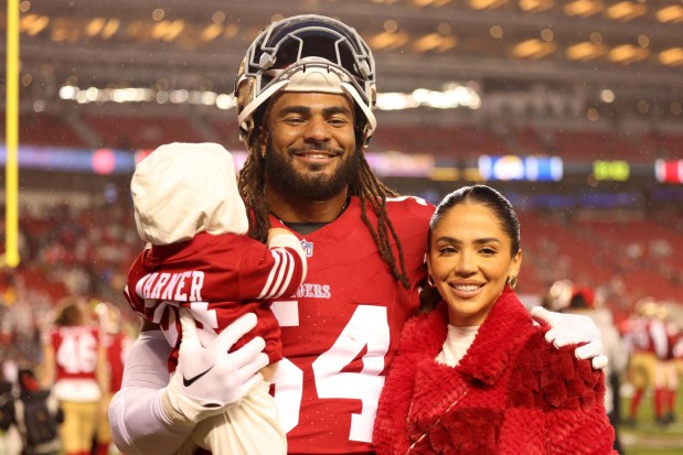 San Francisco 49ers' Fred Warner (54) has his photo taken with his wife, Sydney, and their baby boy, Beau, before an NFL game against the Los Angeles Rams at Levi's Stadium in Santa Clara, Calif., on Thursday, Dec. 12, 2024. (Ray Chavez/Bay Area News Group)