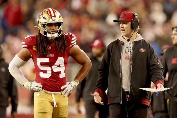 San Francisco 49ers' Fred Warner (54) gets instructions from defensive coordinator Nick Sorensen in the third quarter of an NFL game against the Los Angeles Rams at Levi's Stadium in Santa Clara, Calif., on Thursday, Dec. 12, 2024. (Ray Chavez/Bay Area News Group)