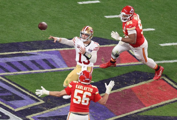 San Francisco 49ers quarterback Brock Purdy (13) under pressure from Kansas City Chiefs' George Karlaftis III (56) and Chris Jones (95) throws a pass to Jauan Jennings (15) for an 8-yard loss in the 3rd quarter of the Super Bowl at Allegiant Stadium in Las Vegas, Nev., on Sunday, Feb. 11, 2024. (Karl Mondon/Bay Area News Group)