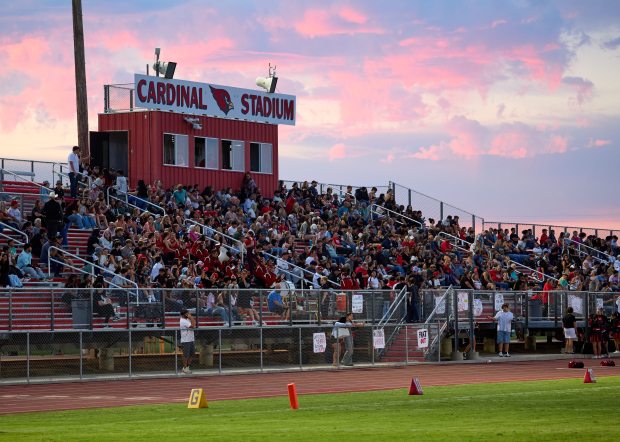 The Corning High School fans pack the grandstands of Cardinal...