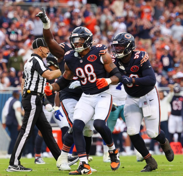 The Chicago Bears defensive celebrates Montez Sweat's (98) sack of...