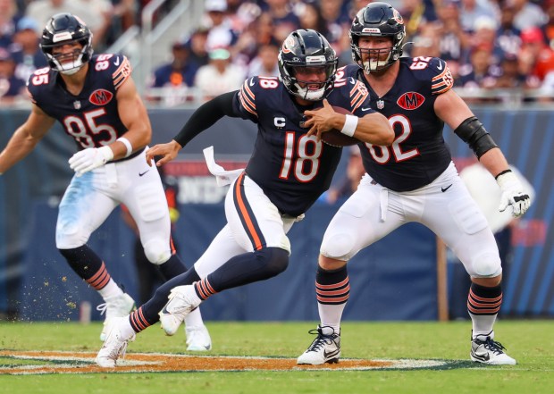 Chicago Bears quarterback Caleb Williams (18) carries the ball in...