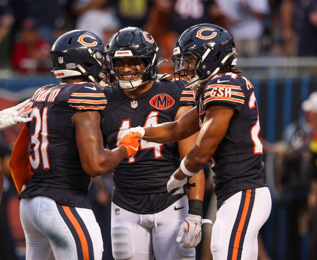 The Chicago Bears defense celebrates an interception by Kevin Byard...