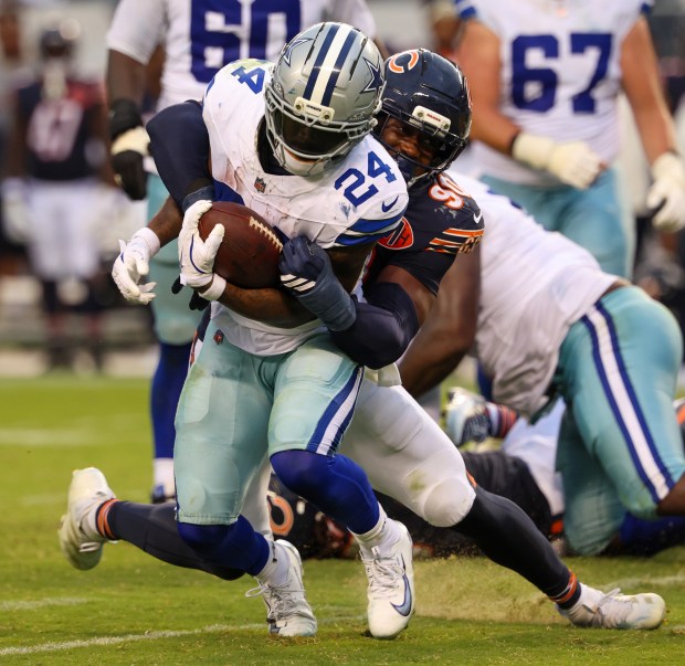 Chicago Bears defensive end Dominique Robinson (90) tackles Dallas Cowboys...